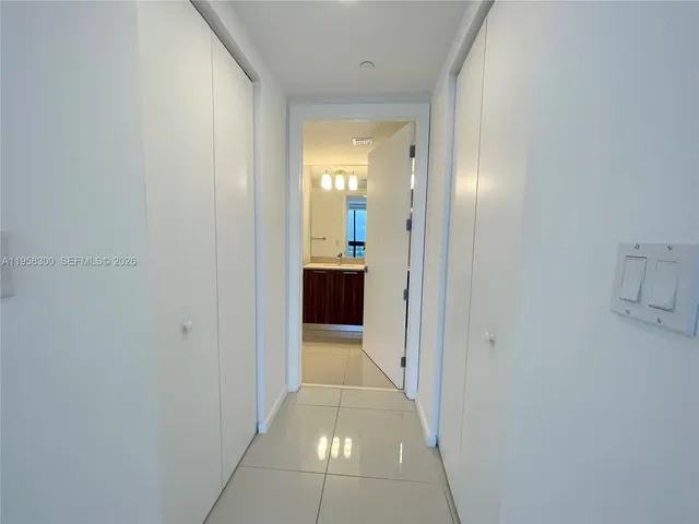 a spacious bathroom with a granite countertop sink a toilet and a mirror