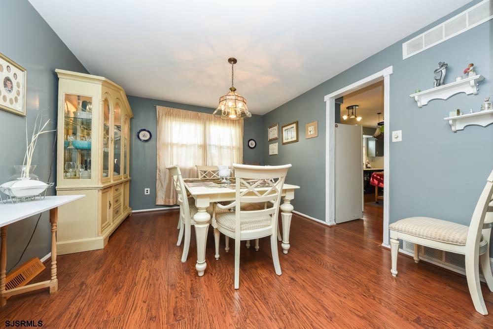 10 Williams Way Ocean View, NJ 08230 - Photo 13 of 28 a dining room with furniture a chandelier and wooden floor