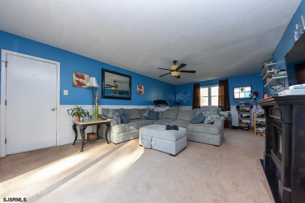 10 Williams Way Ocean View, NJ 08230 - Photo 20 of 28 a living room with fireplace furniture and a flat screen tv