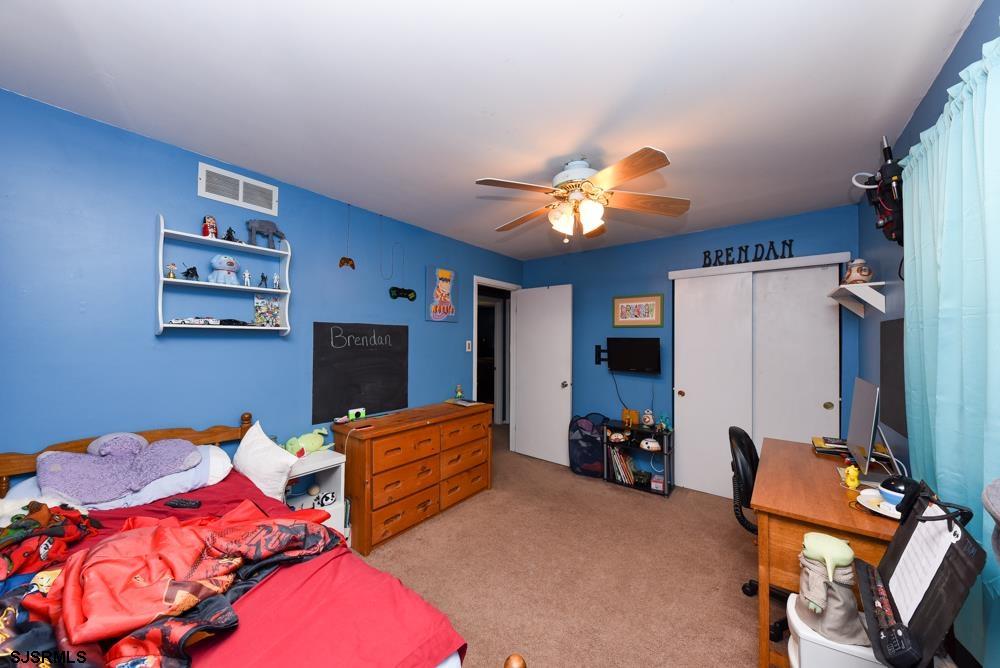 10 Williams Way Ocean View, NJ 08230 - Photo 23 of 28 a bedroom with furniture and a chandelier