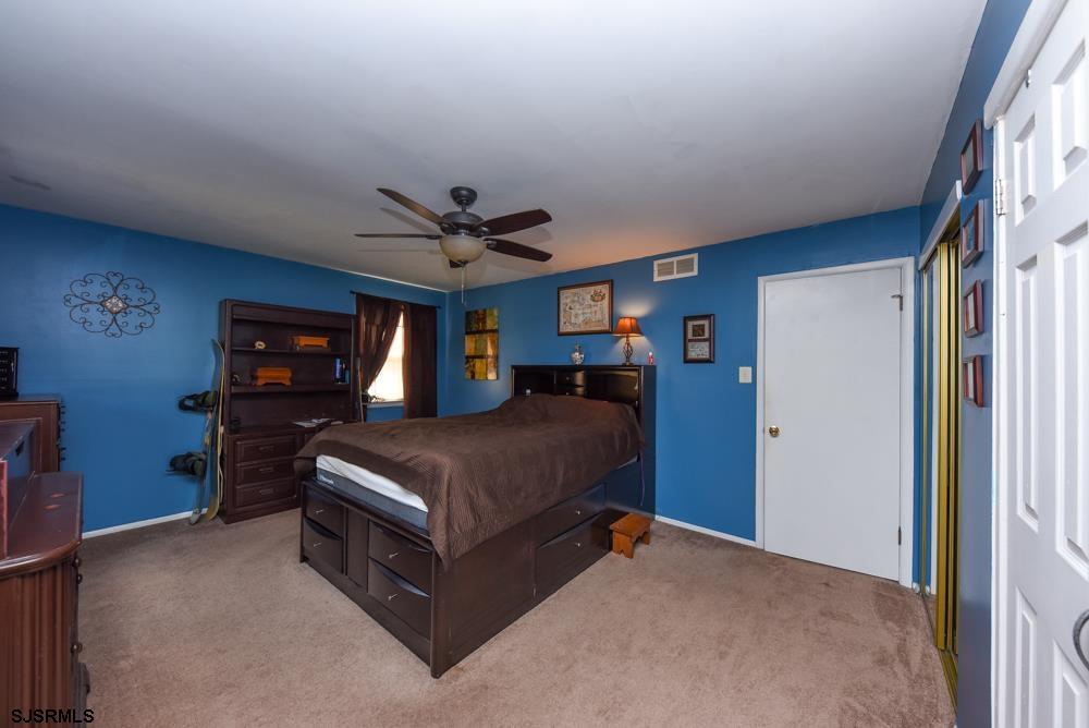 10 Williams Way Ocean View, NJ 08230 - Photo 27 of 28 a spacious bedroom with a bed and a tv on the dresser