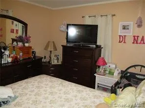 a room with a bed and a flat screen tv