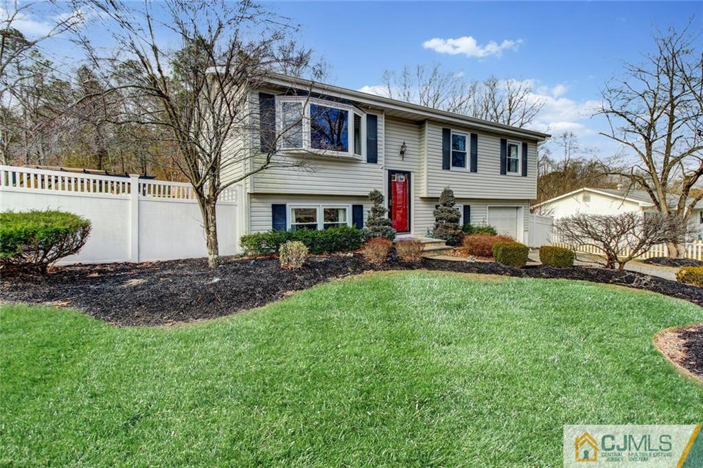 9 A Birch Drive Jackson, NJ 08527 - Photo 2 of 27 a front view of a house with a garden and plants