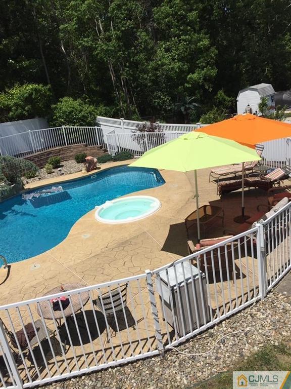 9 A Birch Drive Jackson, NJ 08527 - Photo 26 of 27 a view of a swimming pool with a lounge chair