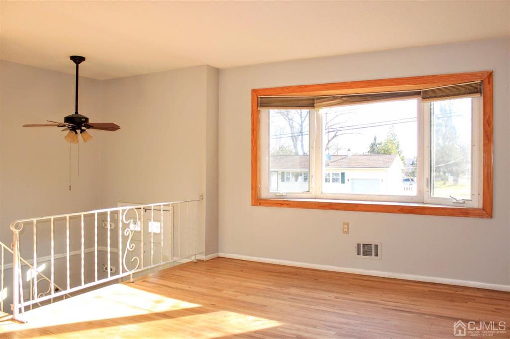 9 A Birch Drive Jackson, NJ 08527 - Photo 4 of 27 a view of an empty room with wooden floor and a window