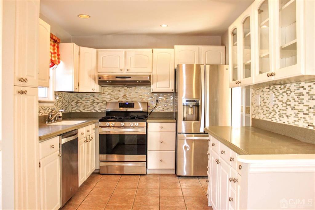 9 A Birch Drive Jackson, NJ 08527 - Photo 9 of 27 a kitchen with stainless steel appliances granite countertop a stove a refrigerator and a microwave