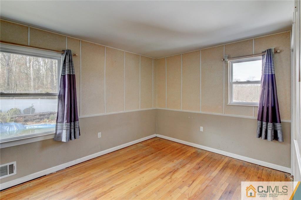 9 A Birch Drive Jackson, NJ 08527 - Photo 10 of 27 a view of empty room with wooden floor and fan