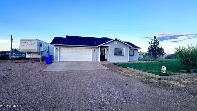 a yellow and red house with a yard