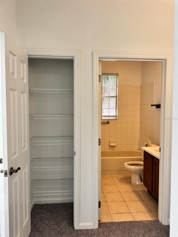 3001 Greystone Loop, Unit 201 Kissimmee, FL 34741 - Photo 15 of 26 a bathroom with a toilet and a shower