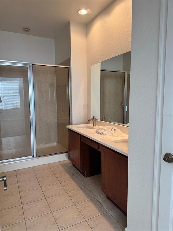 3001 Greystone Loop, Unit 201 Kissimmee, FL 34741 - Photo 16 of 26 a bathroom with a sink mirror and shower