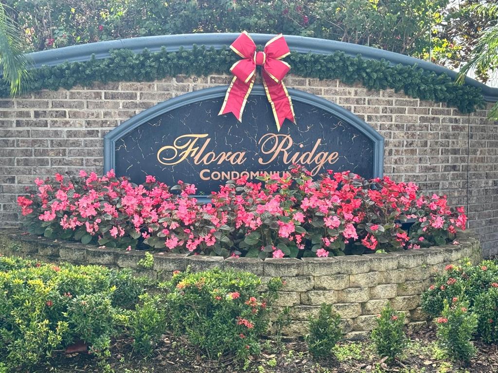 3001 Greystone Loop, Unit 201 Kissimmee, FL 34741 - Photo 22 of 26 a sign that is in front of flowers