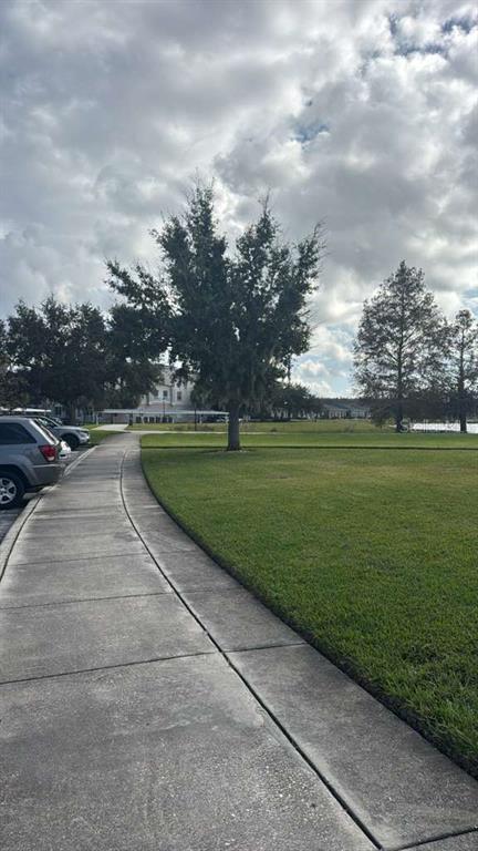 3001 Greystone Loop, Unit 201 Kissimmee, FL 34741 - Photo 23 of 26 a view of a golf course with a garden