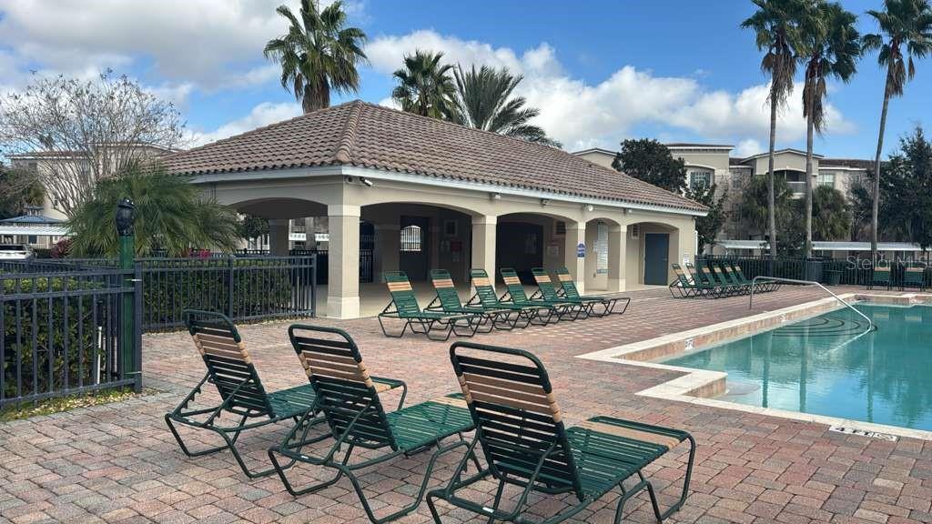 3001 Greystone Loop, Unit 201 Kissimmee, FL 34741 - Photo 26 of 26 a view of a white house with a yard patio and swimming pool