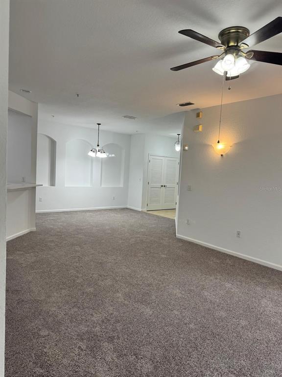 3001 Greystone Loop, Unit 201 Kissimmee, FL 34741 - Photo 3 of 26 a view of a livingroom with a ceiling fan window and a chandelier fan
