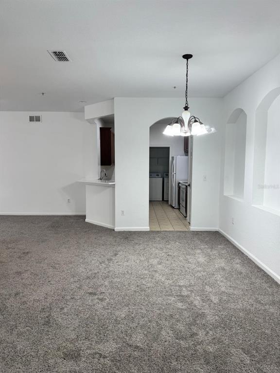 3001 Greystone Loop, Unit 201 Kissimmee, FL 34741 - Photo 6 of 26 a view of a kitchen with a sink and a chandelier