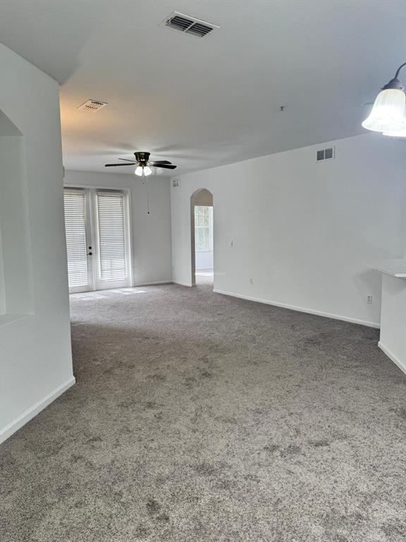 3001 Greystone Loop, Unit 201 Kissimmee, FL 34741 - Photo 7 of 26 a view of a livingroom with a ceiling fan