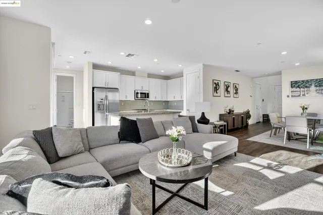 a living room with furniture kitchen and a table