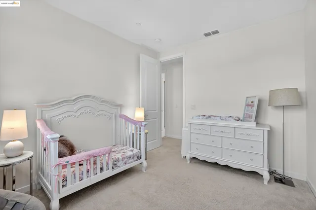 a bedroom with furniture and a baby crib