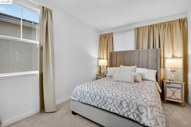 a bedroom with a large bed and a window