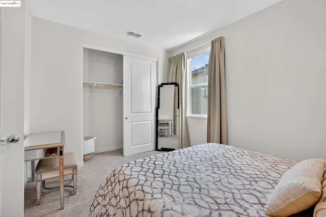 a bedroom with a bed and a mirror