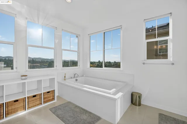 a white bath tub sitting next to a window