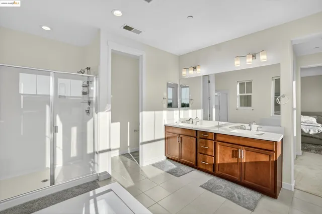 a large bathroom with a double vanity sink and a mirror