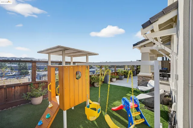 a living room with furniture a fireplace and a large window