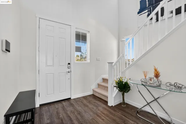 a living room with furniture a flat screen tv and a window