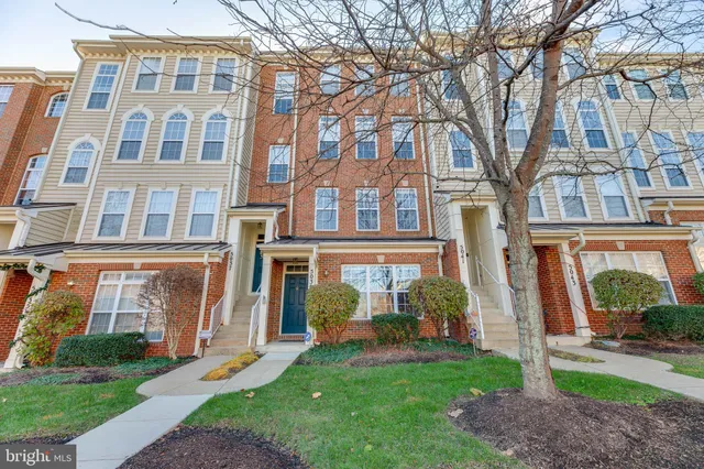 front view of a brick house with a yard