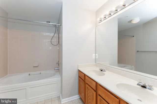 a bathroom with a tub sink and mirror