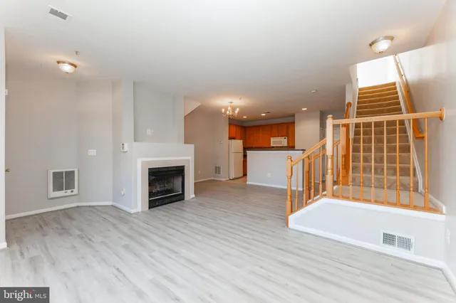 a view of a livingroom with a fireplace and window