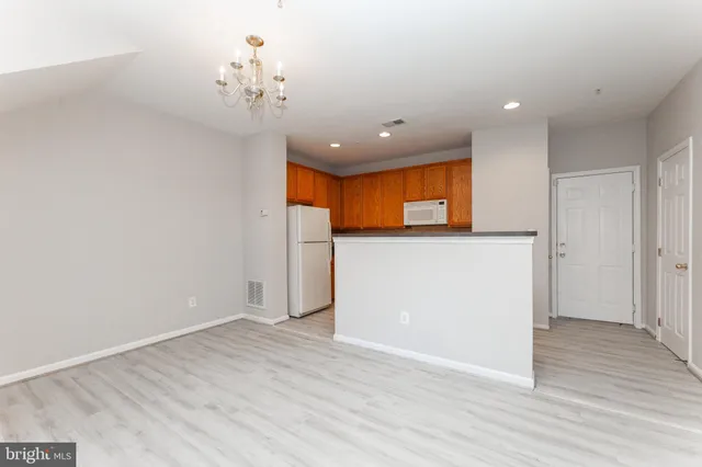 a view of a room with wooden floor and staircase