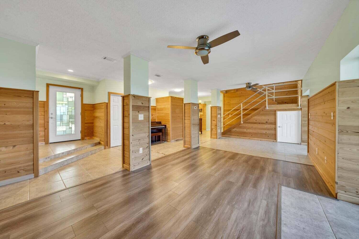 2030 Bay Grove Road Freeport, FL 32439 - Photo 4 of 22 a view of a livingroom with wooden floor and a ceiling fan