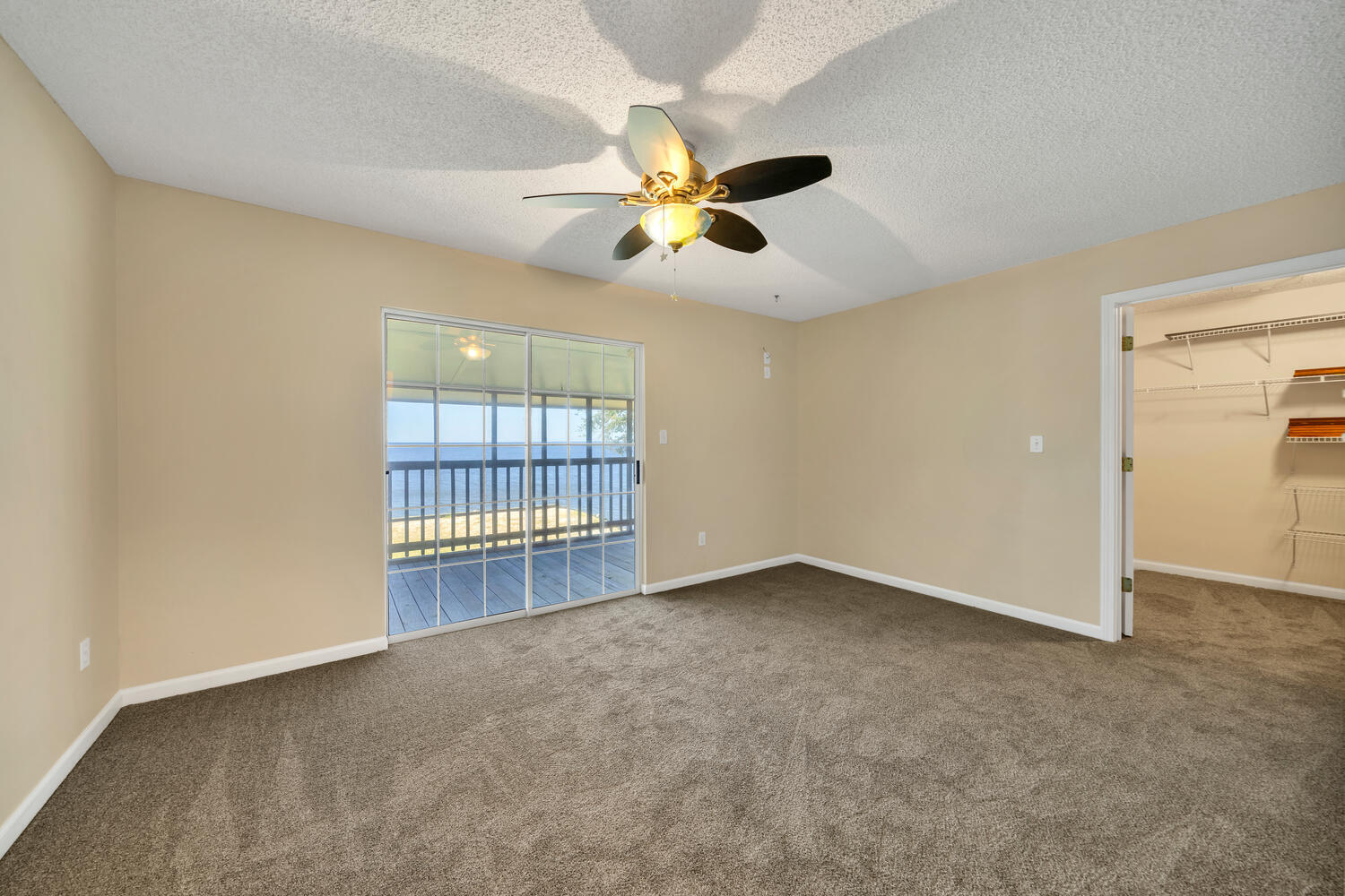 2030 Bay Grove Road Freeport, FL 32439 - Photo 9 of 22 an empty room with chandelier fan and windows