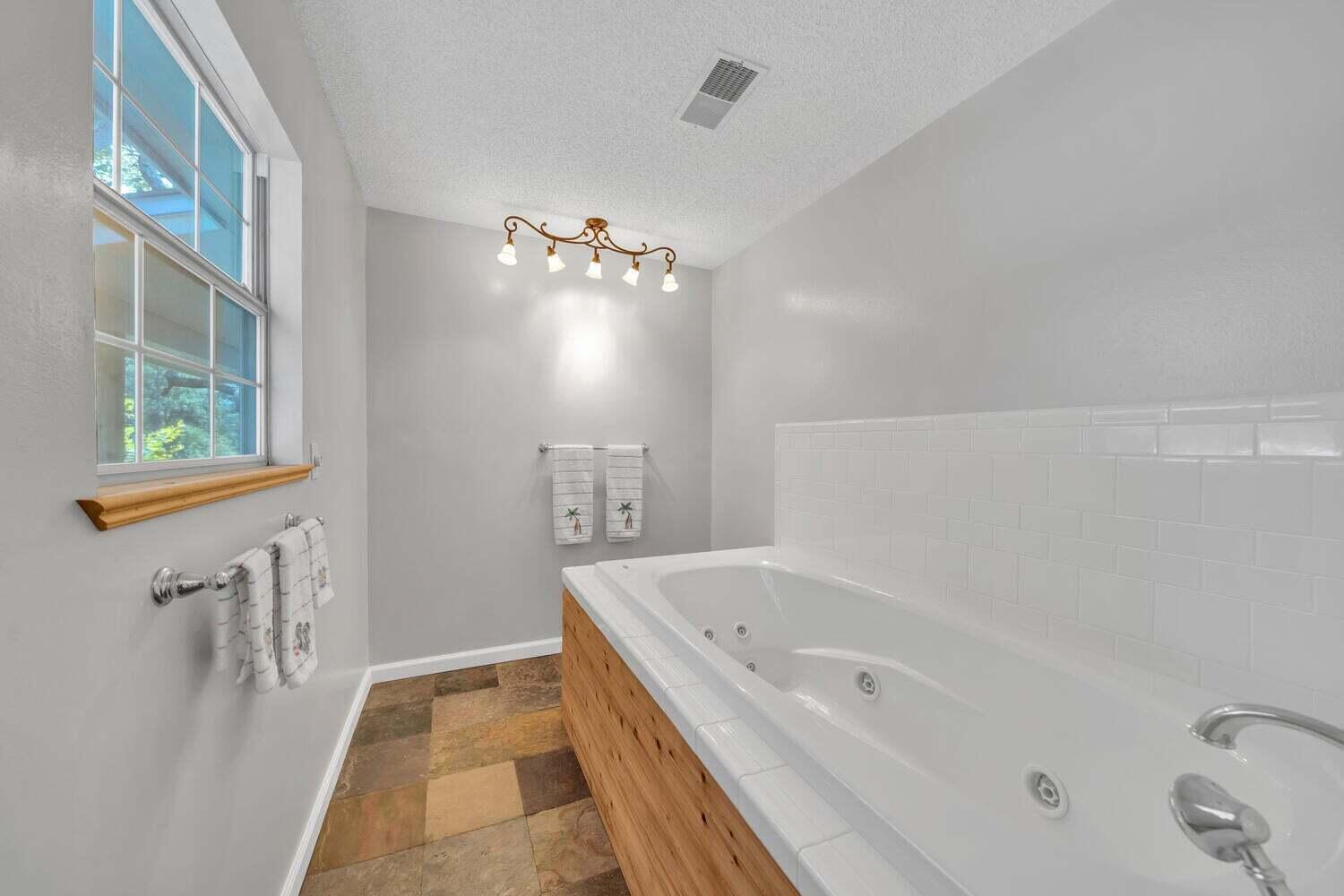 2030 Bay Grove Road Freeport, FL 32439 - Photo 10 of 22 a bathroom with a bathtub and shower
