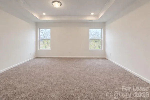 an empty room with windows and closet