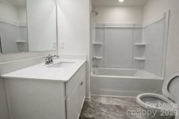 a bathroom with a sink a toilet and a bathtub