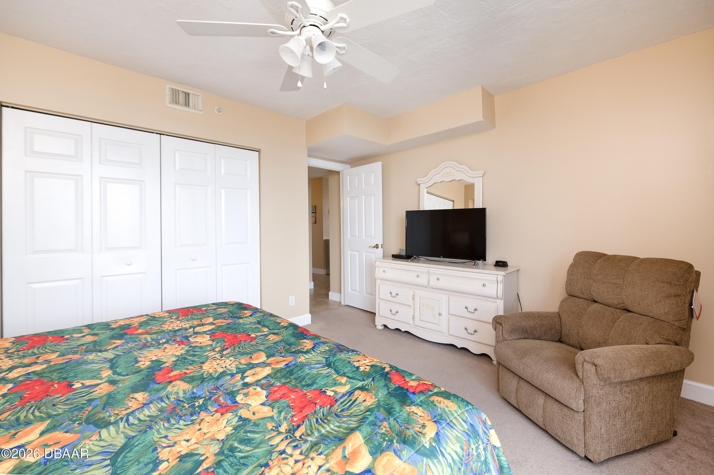 4575 South Atlantic Avenue, Unit 6701 Ponce Inlet, FL 32127 - Photo 27 of 35 a bedroom with a bed and a television