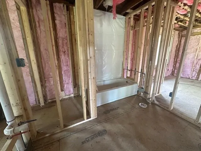 a view of a bathroom with tub and window