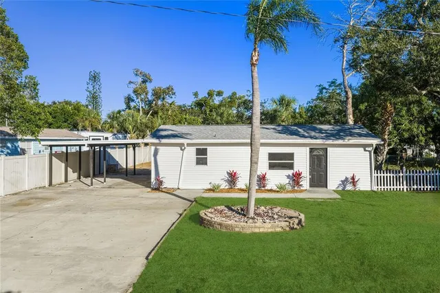 a front view of a house with a garden and yard