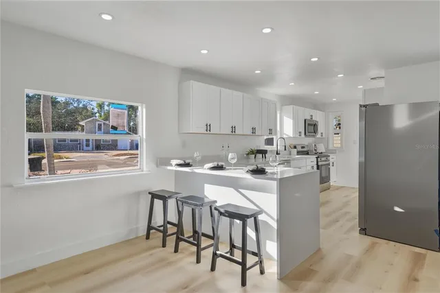 a kitchen with a sink cabinets and window