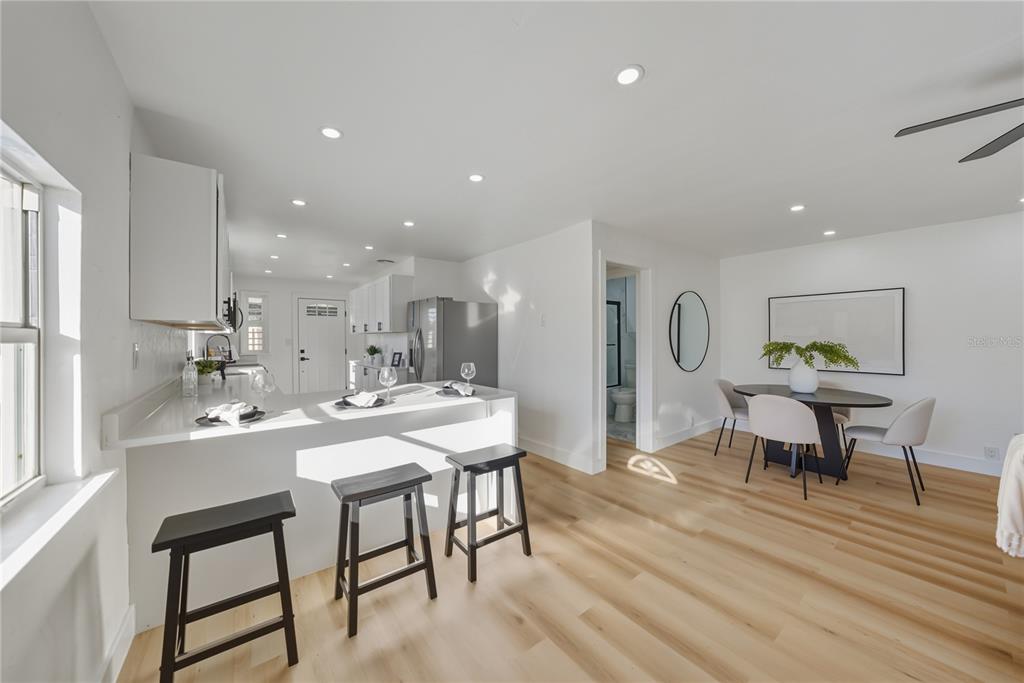 542 64th Street South St. Petersburg, FL 33707 - Photo 12 of 49 a view of a dining room with furniture and wooden floor