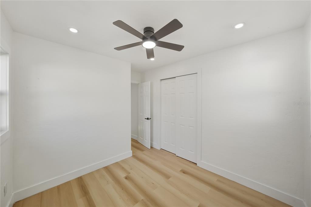 542 64th Street South St. Petersburg, FL 33707 - Photo 22 of 53 a view of empty room with wooden floor and ceiling fan