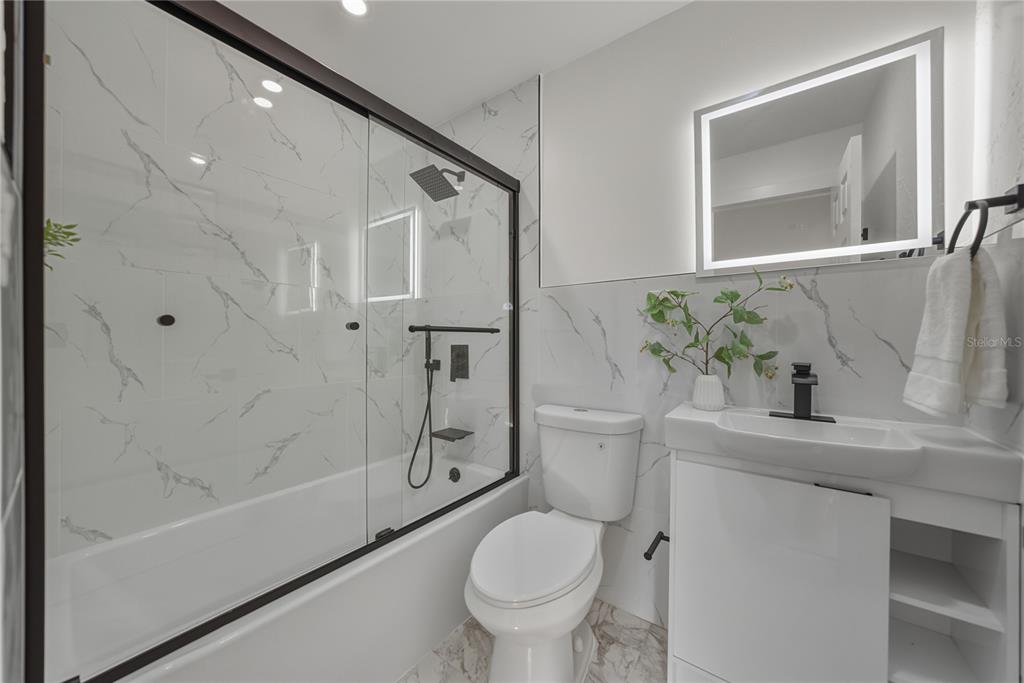 542 64th Street South St. Petersburg, FL 33707 - Photo 23 of 53 a bathroom with a sink toilet and shower