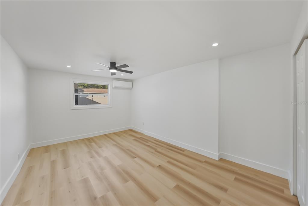 542 64th Street South St. Petersburg, FL 33707 - Photo 25 of 53 an empty room with wooden floor and windows