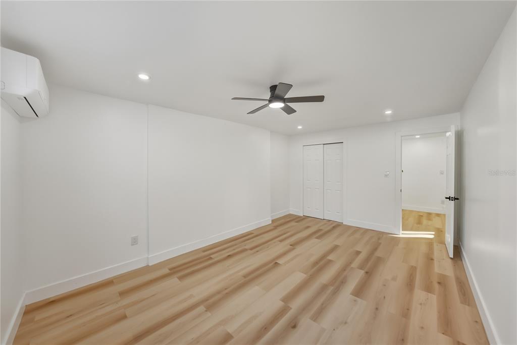 542 64th Street South St. Petersburg, FL 33707 - Photo 26 of 49 a view of empty room with wooden floor and fan