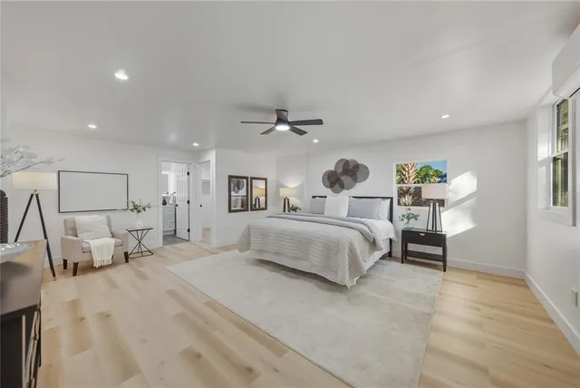 a spacious bedroom with a bed and a chandelier