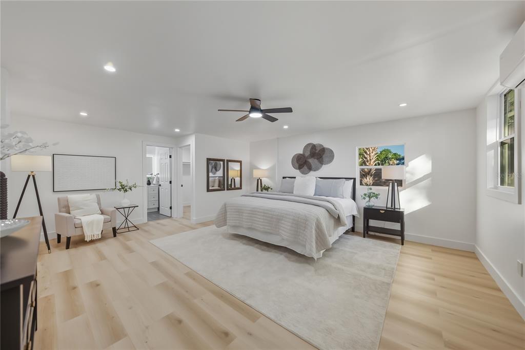 542 64th Street South St. Petersburg, FL 33707 - Photo 28 of 49 a spacious bedroom with a bed and a chandelier