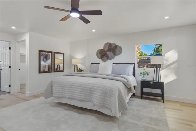 a bedroom with a bed and a chandelier