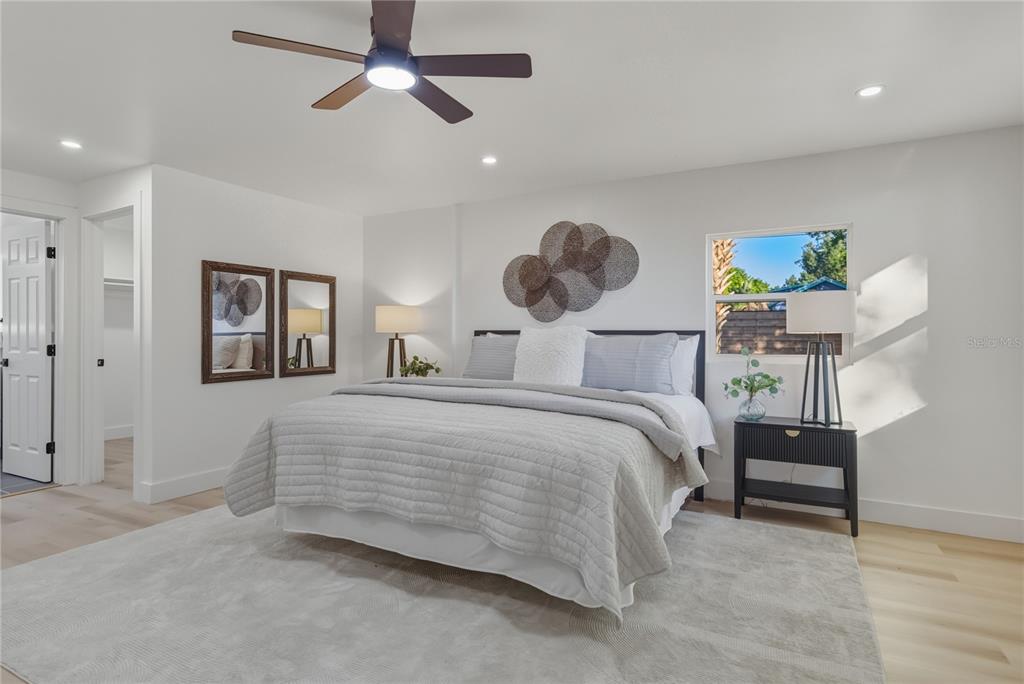 542 64th Street South St. Petersburg, FL 33707 - Photo 29 of 49 a bedroom with a bed and a chandelier